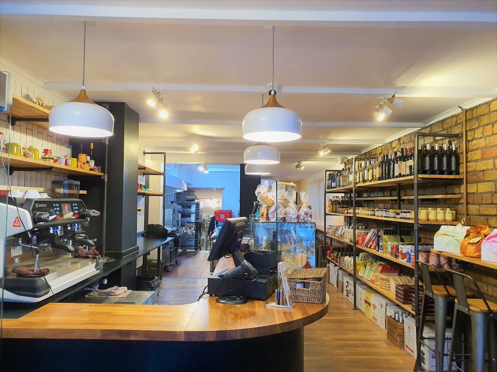 Completed shop refurbishment in Horfield, Bristol, showing pendant lights, ceiling spotlights and the shop counter