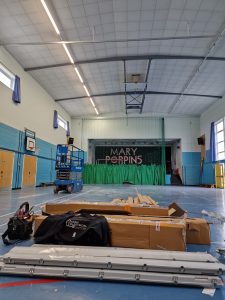 Ceiling lighting and installation equipment in a Bristol school hall during an LED upgrade