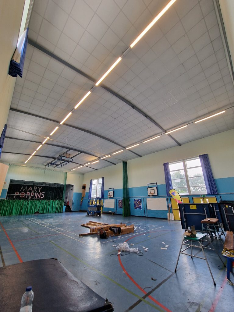 LED ceiling lights illuminated in a Bristol school hall during the lighting upgrade