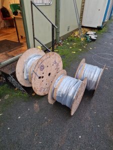 Three cable drums beside a portable cabin during the Fishponds electrical installation