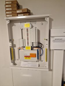 Open three-phase distribution board photographed during installation in Fishponds, Bristol