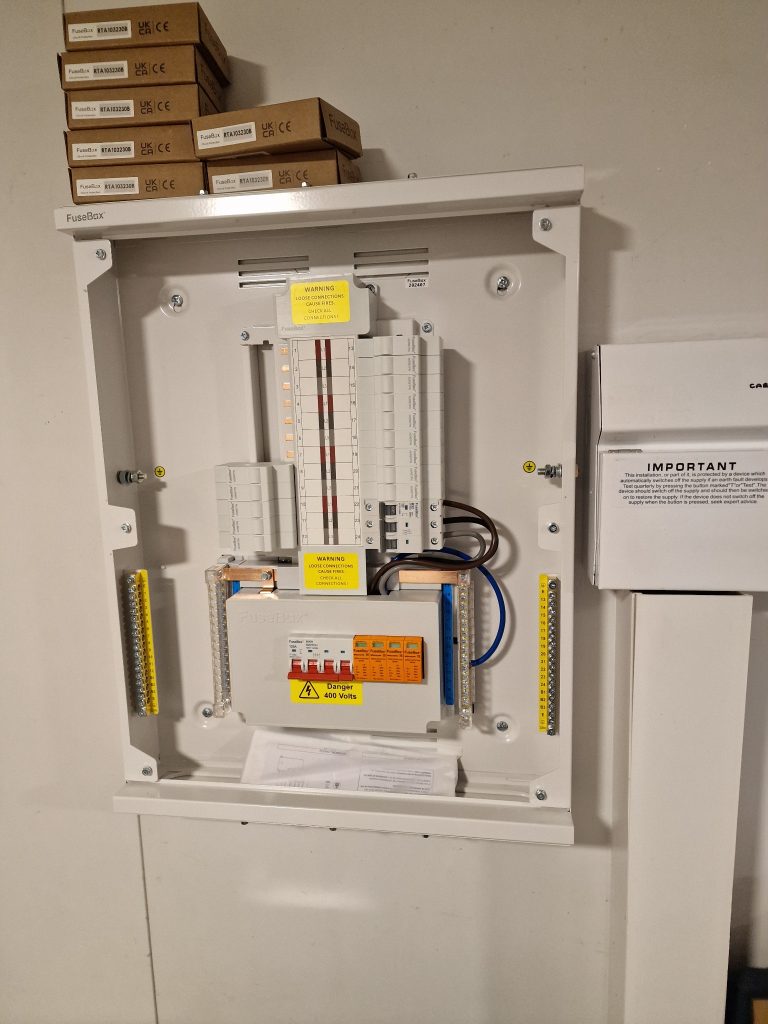 Open three-phase distribution board photographed during installation in Fishponds, Bristol