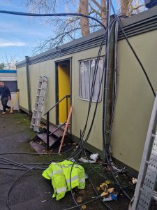 External cable route beside portable cabins during the Fishponds three-phase supply installation