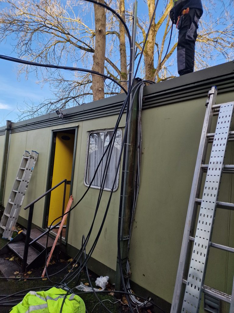 Supply cables being routed outside a portable cabin in Fishponds, Bristol